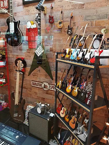 miniature guitar display customers store in Mexico